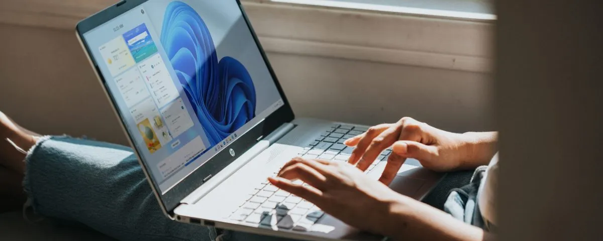 person using Windows 11 computer on lap