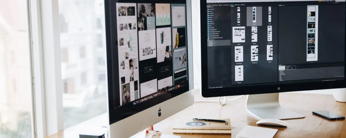 Silver Imac on Top of Brown Wooden Table