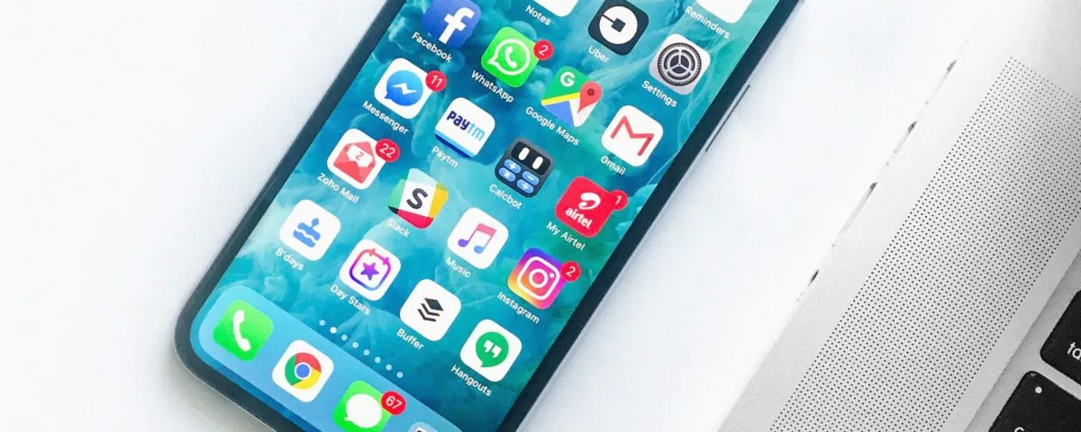 white smartphone near laptop