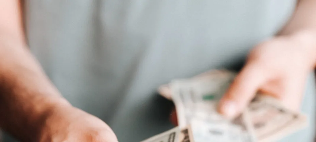 Free Crop man paying with American dollars Stock Photo